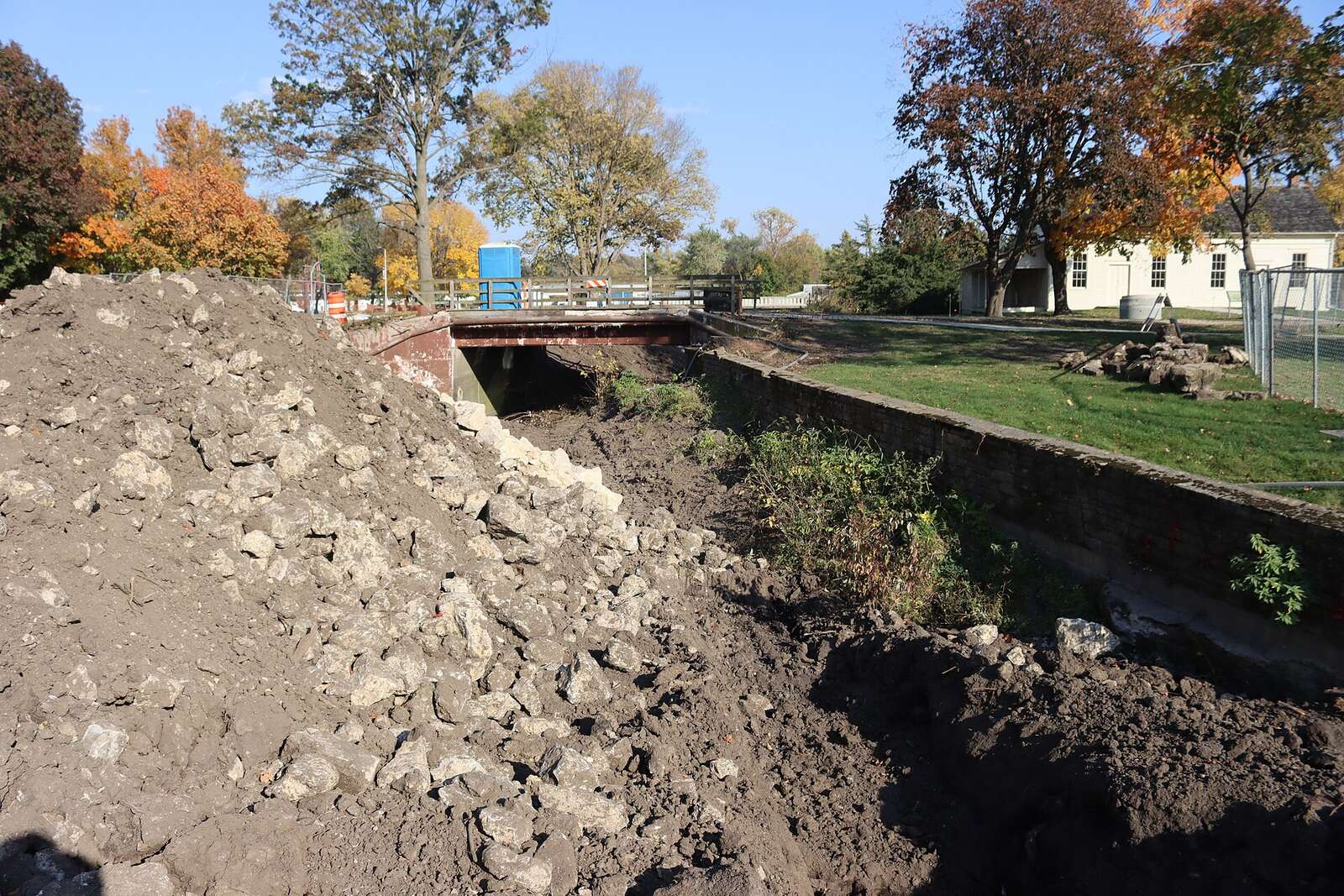 A cut face of excavated ground showing the layers of soil and rock beneath the surface.